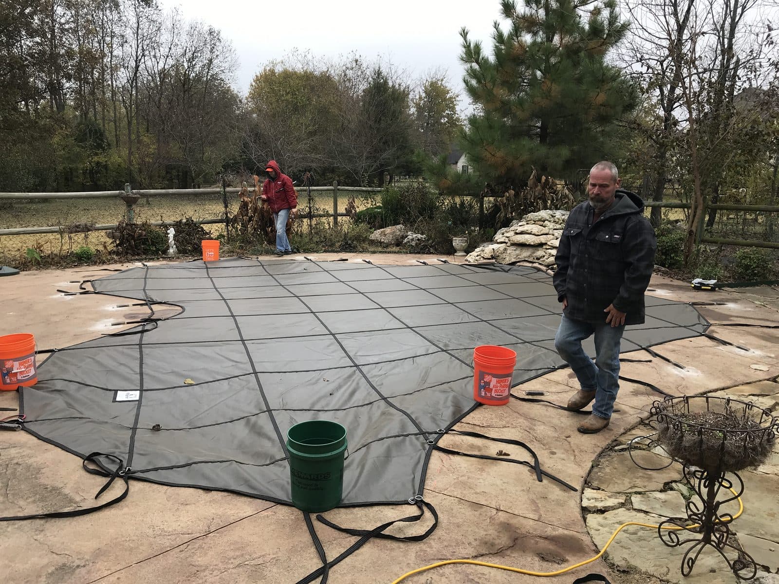 Installing an inground pool safety cover on a stamped-concrete deck